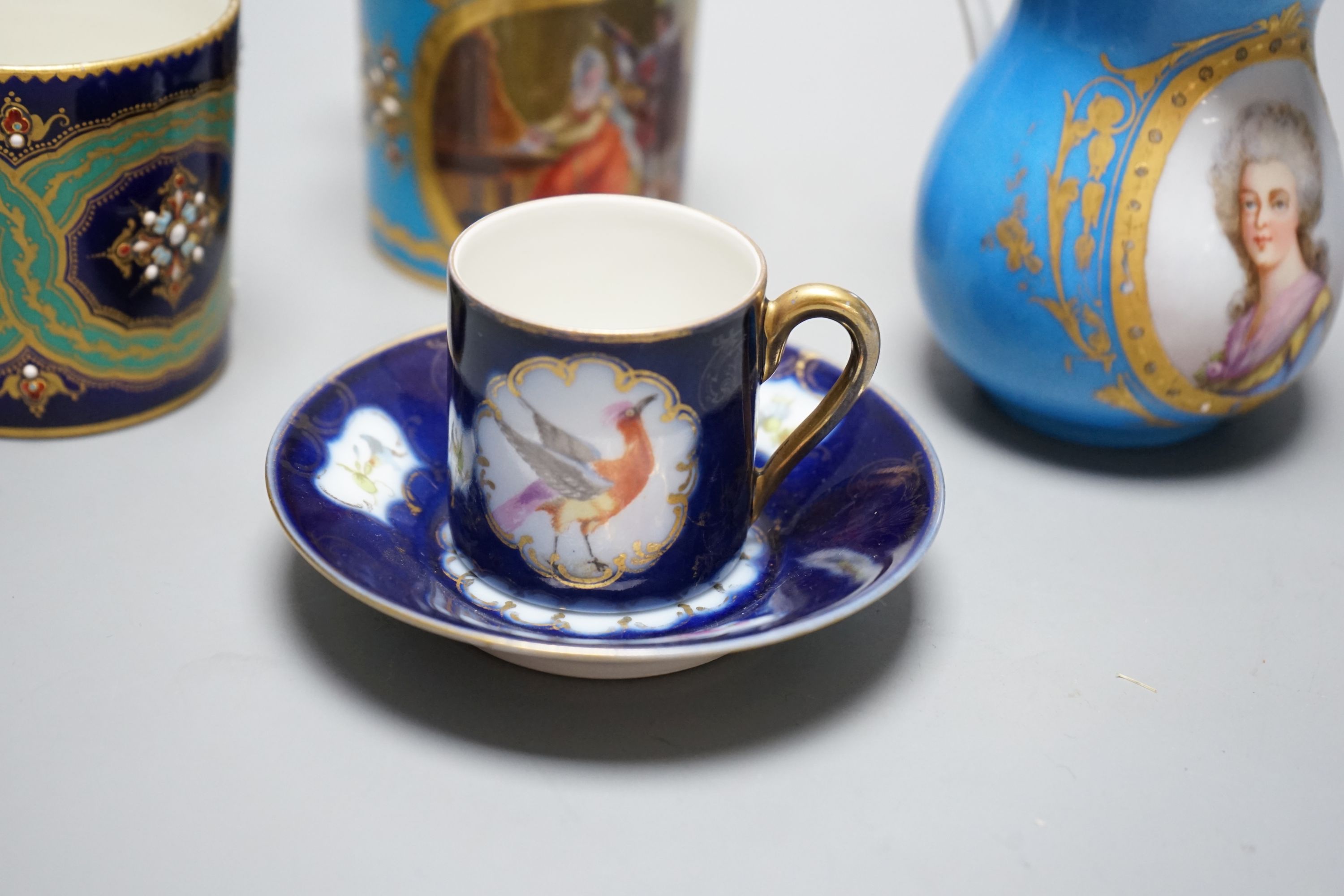 Two Sevres style porcelain coffee cans, cream jug and a cup and saucer, tallest ug 10 cms high.